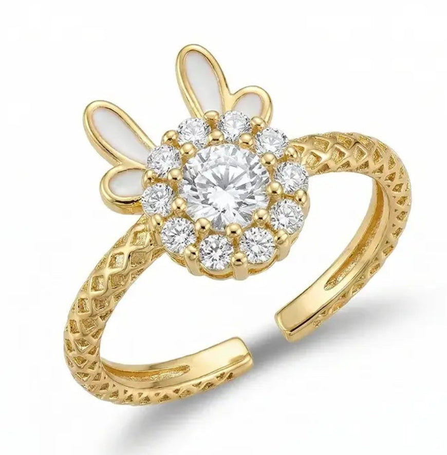 Gold ring with diamond-like stones on a white background