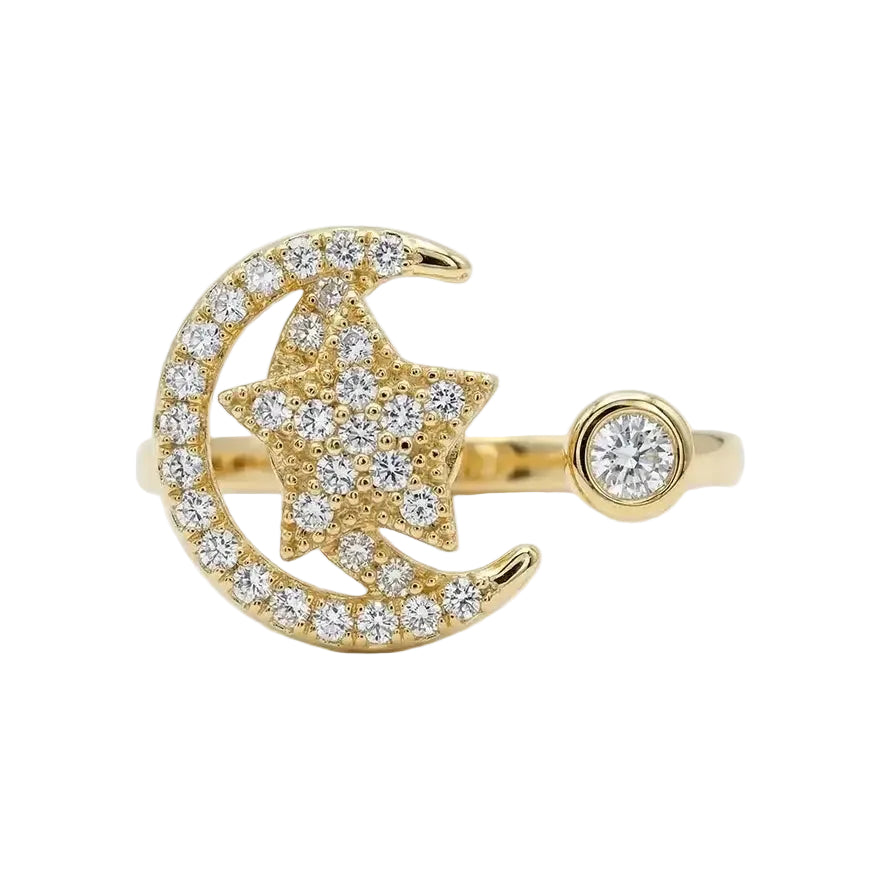 Gold ring with moon and star design on a white background