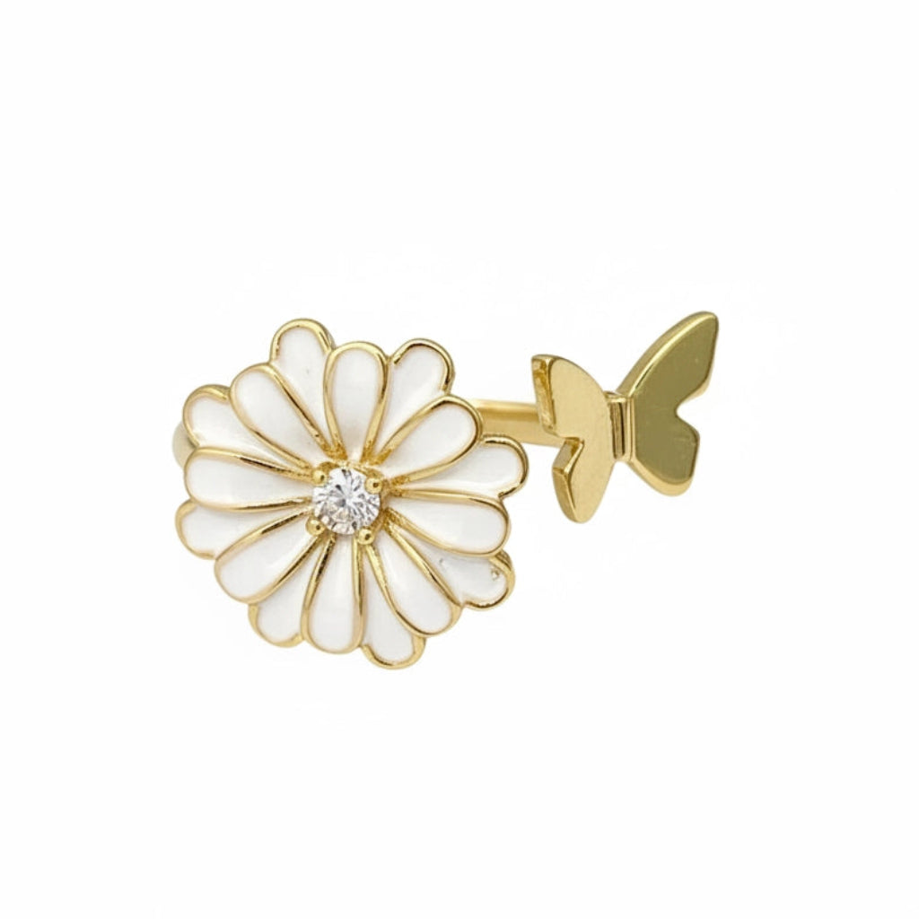 Gold and white flower-shaped earring on a white background