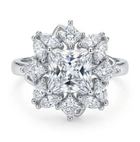 Diamond ring with a star-like design on a white background