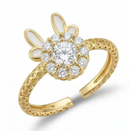 Gold ring with diamond-like stones on a white background