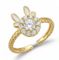 Gold ring with diamond-like stones on a white background