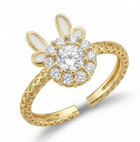 Gold ring with diamond-like stones on a white background