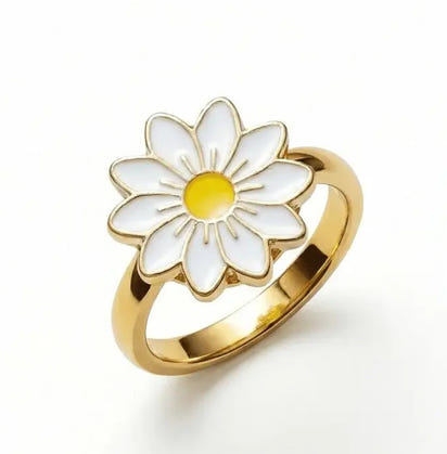 Gold and white flower-shaped earring on a white background