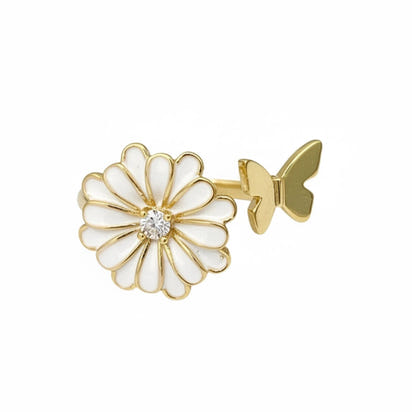 Gold and white flower-shaped earring on a white background