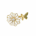 Gold and white flower-shaped earring on a white background