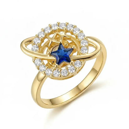 Gold ring with a blue gemstone and diamond accents on a white background