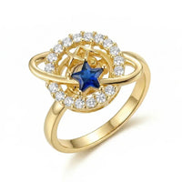 Gold ring with a blue gemstone and diamond accents on a white background