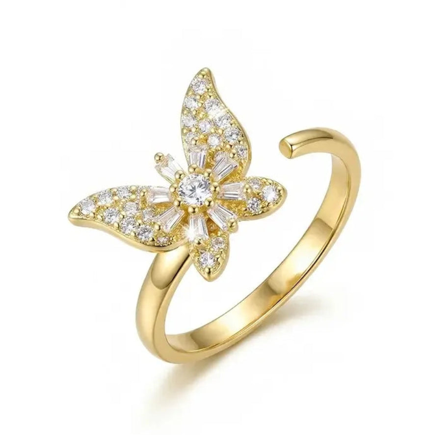 Gold butterfly ring with diamond accents on a white background