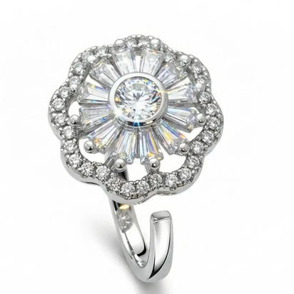 Silver ring with a large central gemstone and smaller stones on a white background