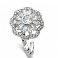Silver ring with a large central gemstone and smaller stones on a white background