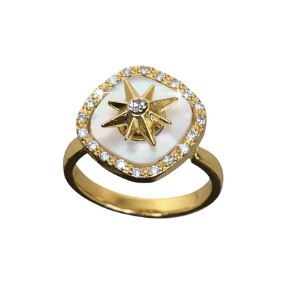 Gold ring with star design and white stone on a white background