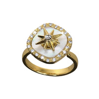 Gold ring with star design and white stone on a white background