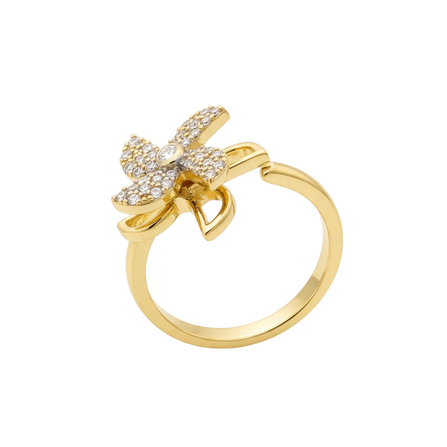 Gold ring with butterfly design on a white background