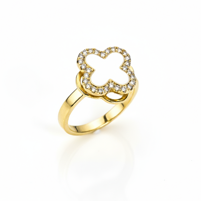 Gold ring with a clover-shaped design on a white background