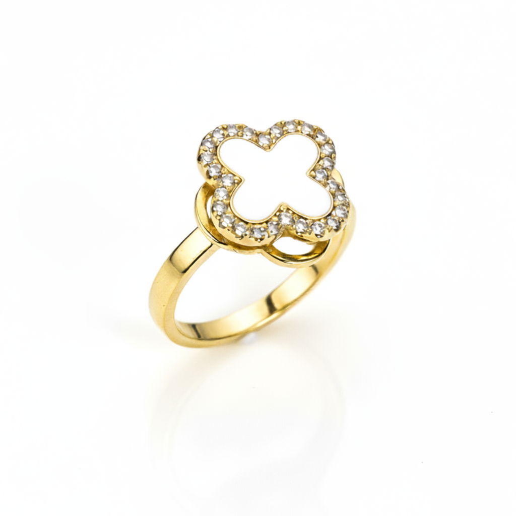 Gold ring with a clover-shaped design on a white background