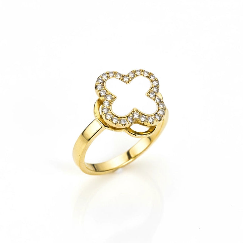Gold ring with a clover-shaped design on a white background
