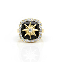 Gold ring with black gemstone and star design on a white background