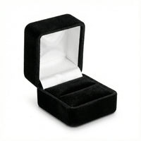 Black velvet jewelry box with white interior on a white background