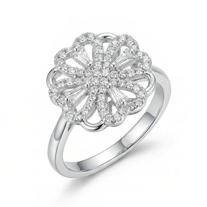 Silver ring with a floral design and clear stones on a white background