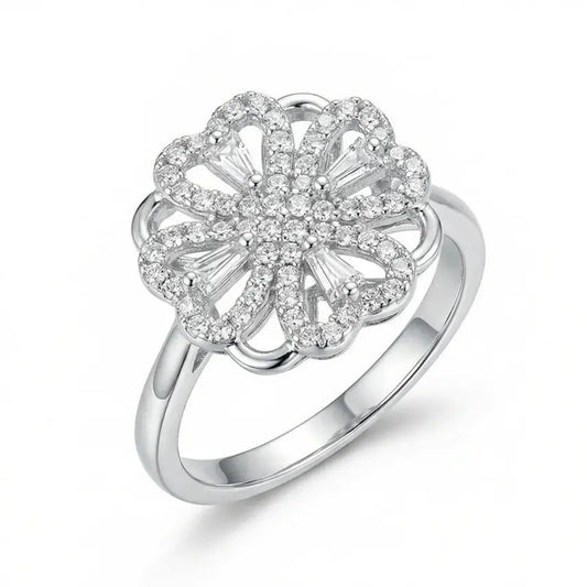 Silver ring with a floral design and clear stones on a white background